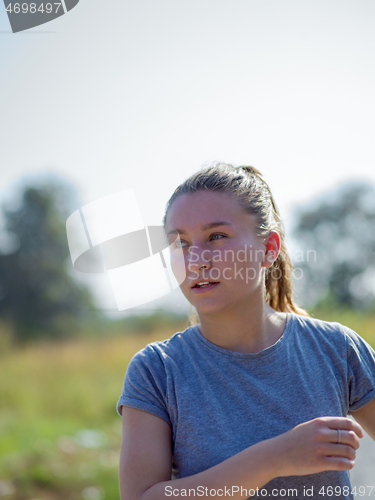 Image of woman jogging along a country road