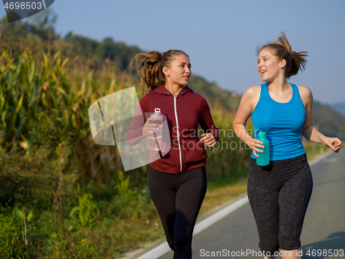 Image of women jogging along a country road