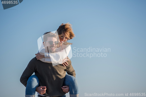 Image of couple having fun at beach during autumn