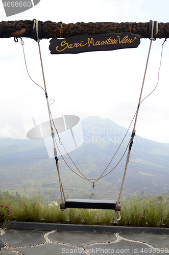 Image of Wooden swing on the rope with view of Batur volcano