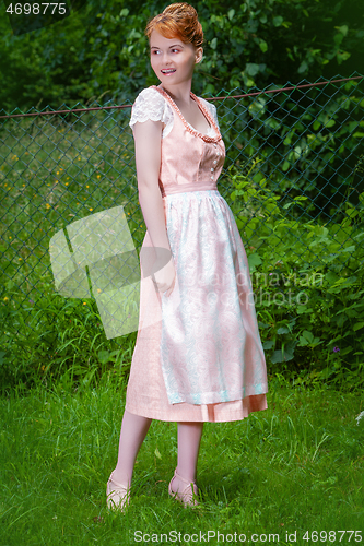 Image of Elegant in a dirndl on the meadow