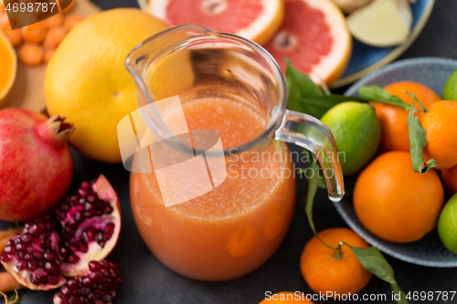 Image of glass jug of juice with fruits and vegetables