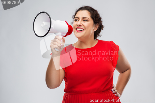 Image of happy woman in red dress speaking to megaphone