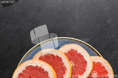 Image of close up of fresh juicy grapefruits on plate