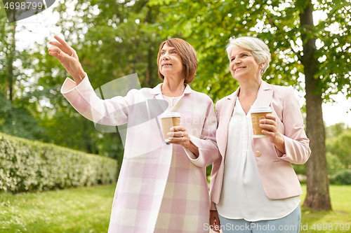 Image of senior women or friends drinking coffee at park