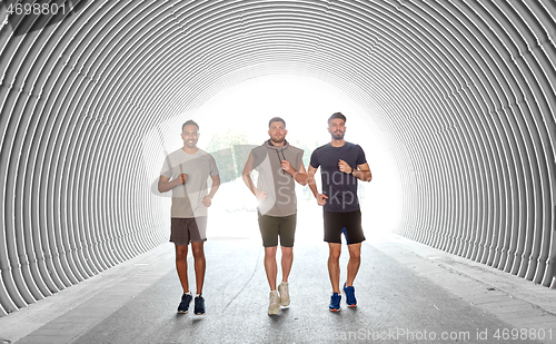 Image of young men or male friends running outdoors