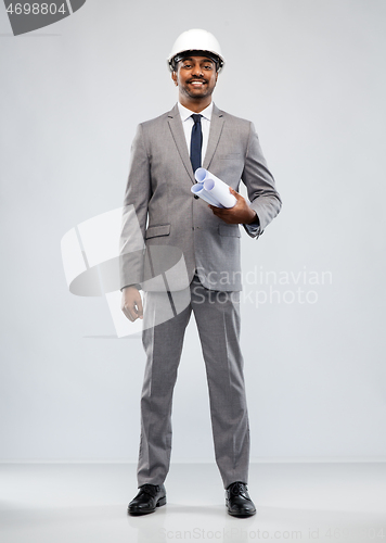 Image of indian male architect in helmet with blueprints