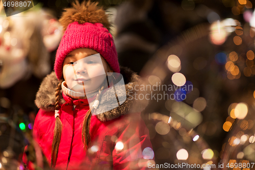 Image of happy little girl at christmas market in winter