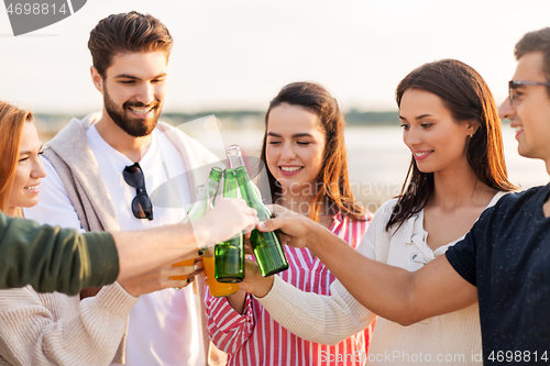 Image of friends toasting non alcoholic drinks on beach