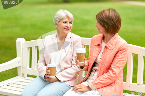 Image of senior women or friends drinking coffee at park