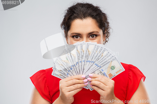 Image of woman hiding her face behind money banknotes