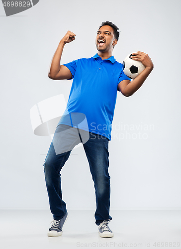 Image of football fan with soccer ball celebrating victory