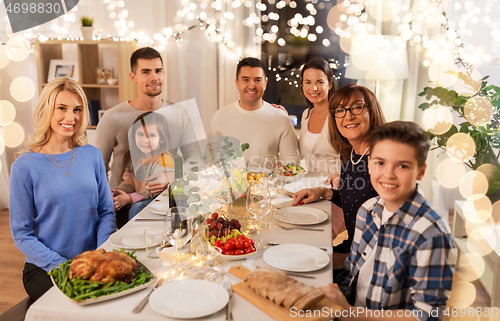 Image of happy family having dinner party at home