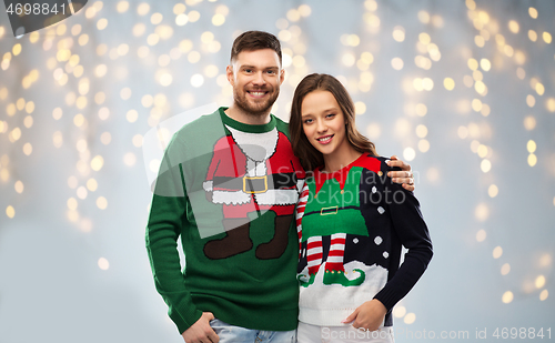 Image of happy couple at christmas ugly sweater party