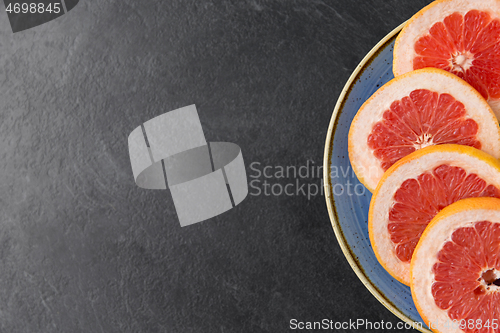 Image of close up of fresh juicy grapefruits on plate