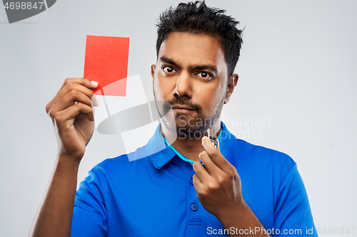 Image of indian referee with whistle showing red card