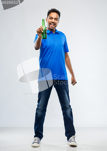 Image of male fan with beer bottle celebrating victory