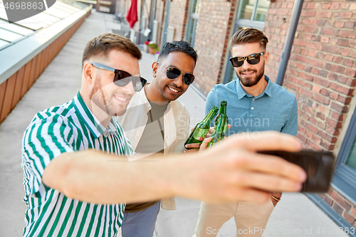 Image of men drinking beer and taking selfie by smartphone