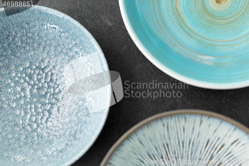 Image of close up of blue ceramic plate on slate background