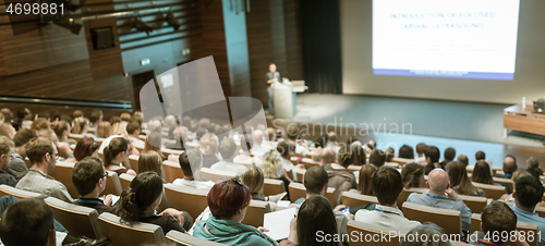 Image of Business speaker giving a talk in conference hall.