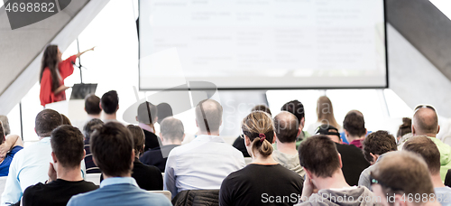 Image of Female speeker having talk at public event.