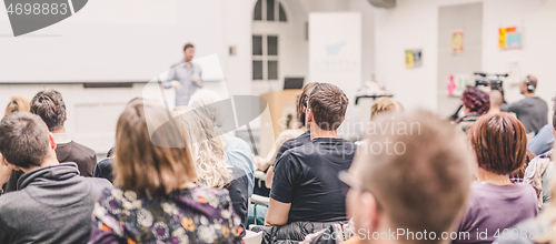 Image of Man giving presentation in lecture hall at university.