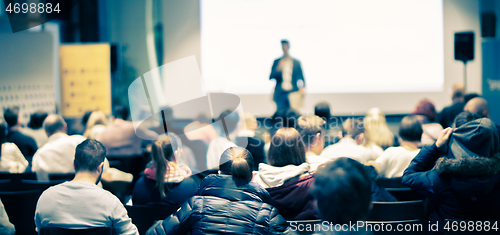 Image of Business speaker giving a talk at business conference event.