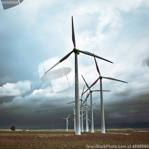 Image of Wind turbines generating electricity in a stormy weather