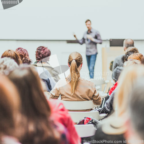 Image of Public speaker giving talk at Business Event.