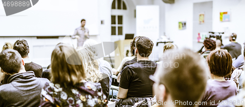 Image of Man giving presentation in lecture hall at university.