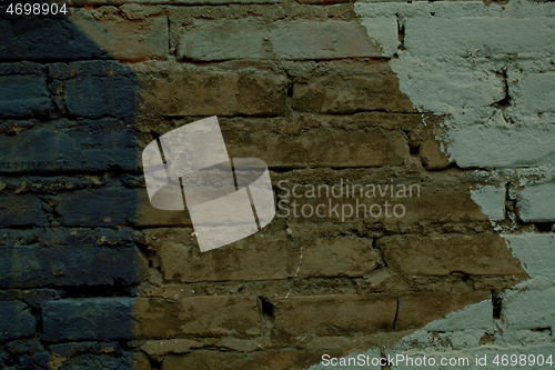 Image of Brick wall with painted pattern on exposed bricks