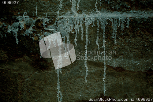 Image of Messy drizzles of white paint on an old wall