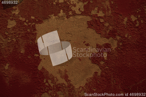 Image of Flaking red paint texture on an old wall