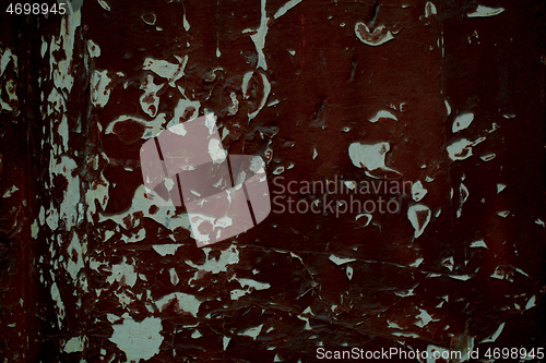 Image of Grungy damaged peeling paint on a wooden door