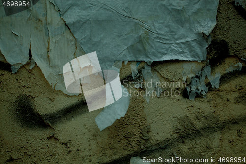 Image of Peeling paper and plaster on a grunge damp wall