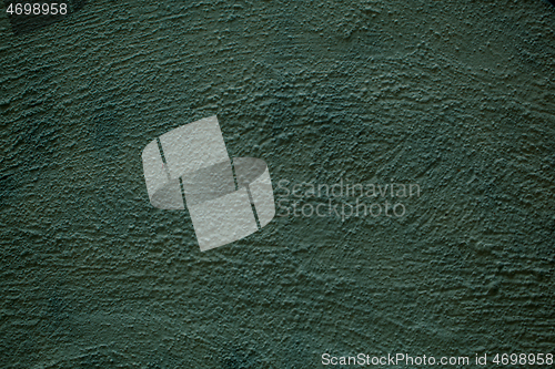 Image of Rough plaster painted dull green wall texture