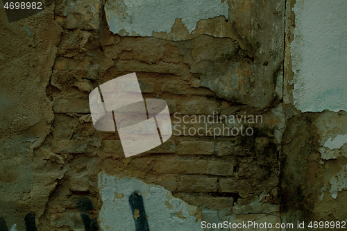 Image of Exposed brickwork on an old damaged wall