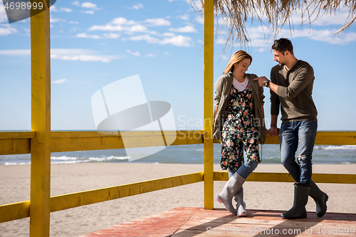 Image of Couple chating and having fun at beach bar