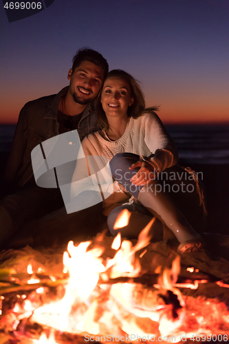 Image of portrait of young Couple enjoying  at night on the beach