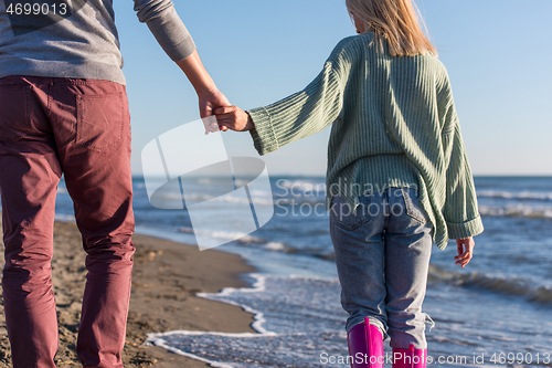 Image of Loving young couple on a beach at autumn sunny day