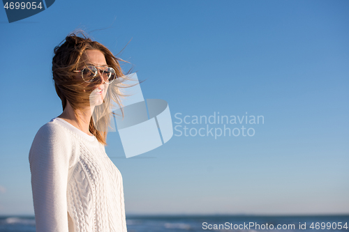 Image of Young woman enjoying the warm autumn day