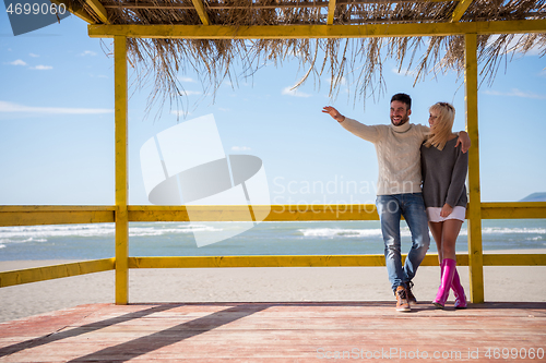 Image of Couple chating and having fun at beach bar