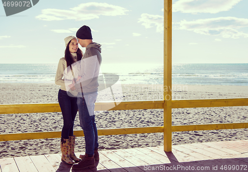 Image of Couple chating and having fun at beach bar