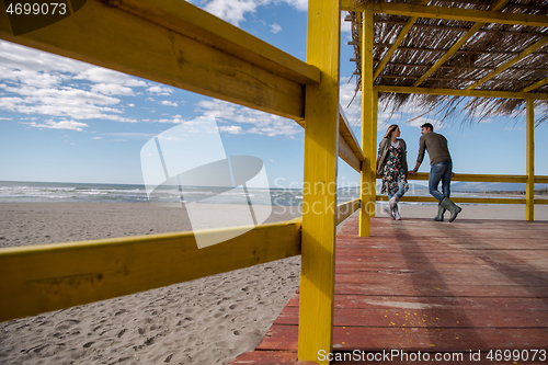 Image of Couple chating and having fun at beach bar