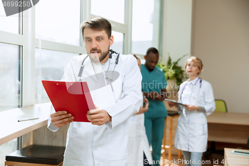Image of Beautiful surprised doctor over hospital background