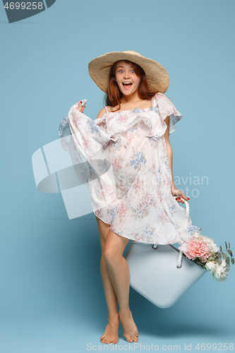 Image of Young beautiful pregnant woman posing on blue background