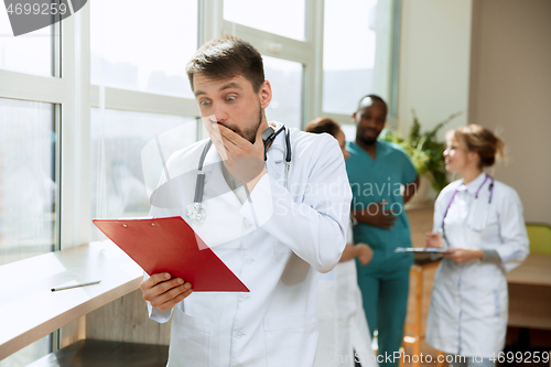 Image of Beautiful surprised doctor over hospital background