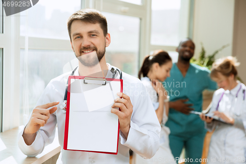 Image of Beautiful smiling doctor over hospital background