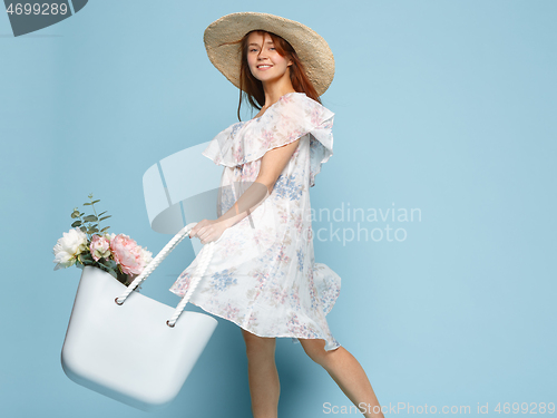 Image of Young beautiful pregnant woman posing on blue background