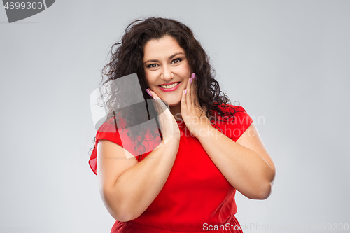 Image of happy woman in red dress over grey background